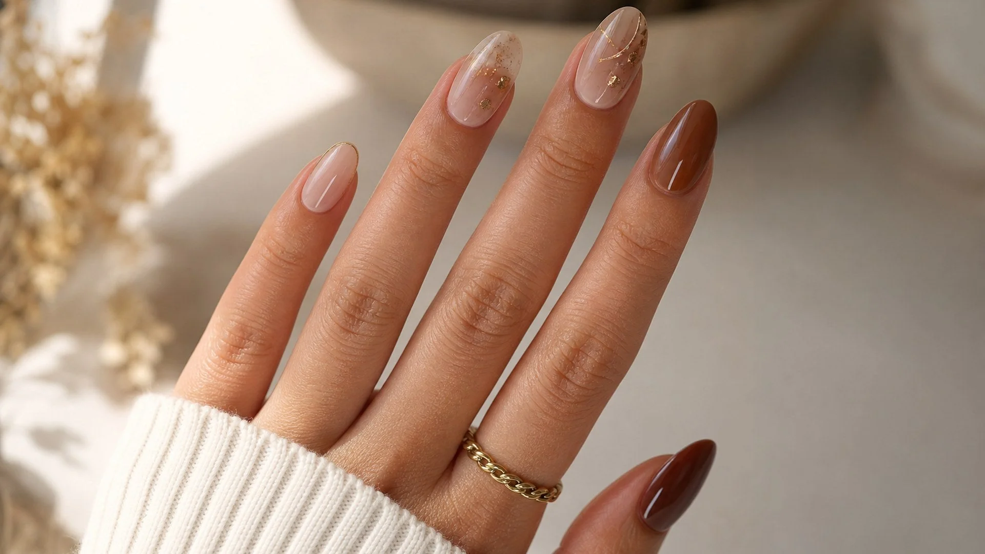 Almond nails with nude, gold leaf and chocolate tones by Wijatawu Nails